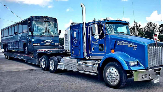 Priority Towing heavy-duty wrecker hauling a large truck in Houston