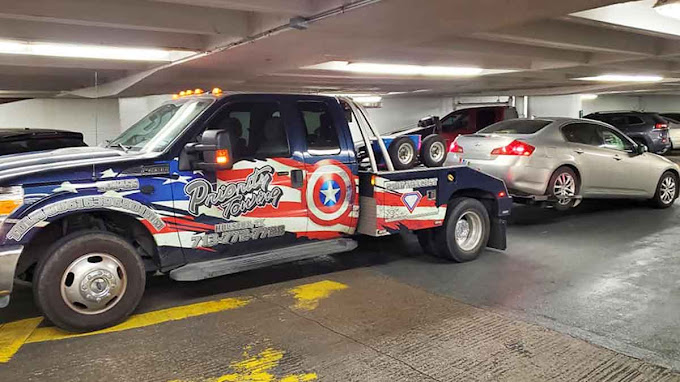 Priority Towing light-duty wrecker loading a vehicle in Houston